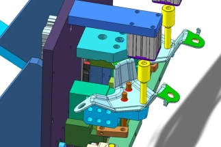 A prototype device for welding car locks placed on a workshop table, prepared for testing.